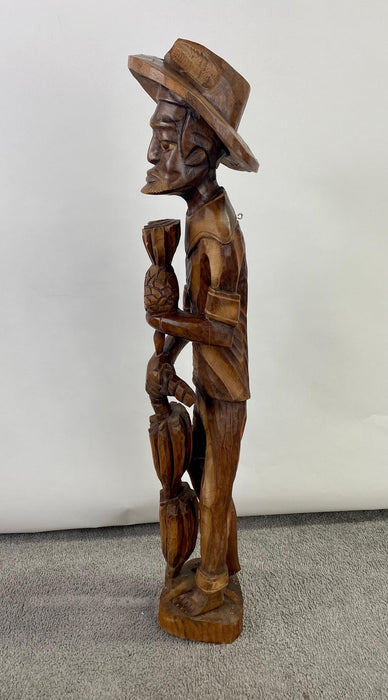 Folk Art Wood Sculpture of a Caribbean Man Holding a Pineapple