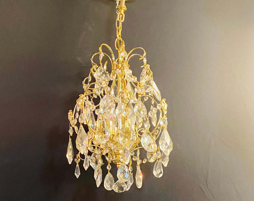 1960s Hollywood Regency brass black crystal chandelier